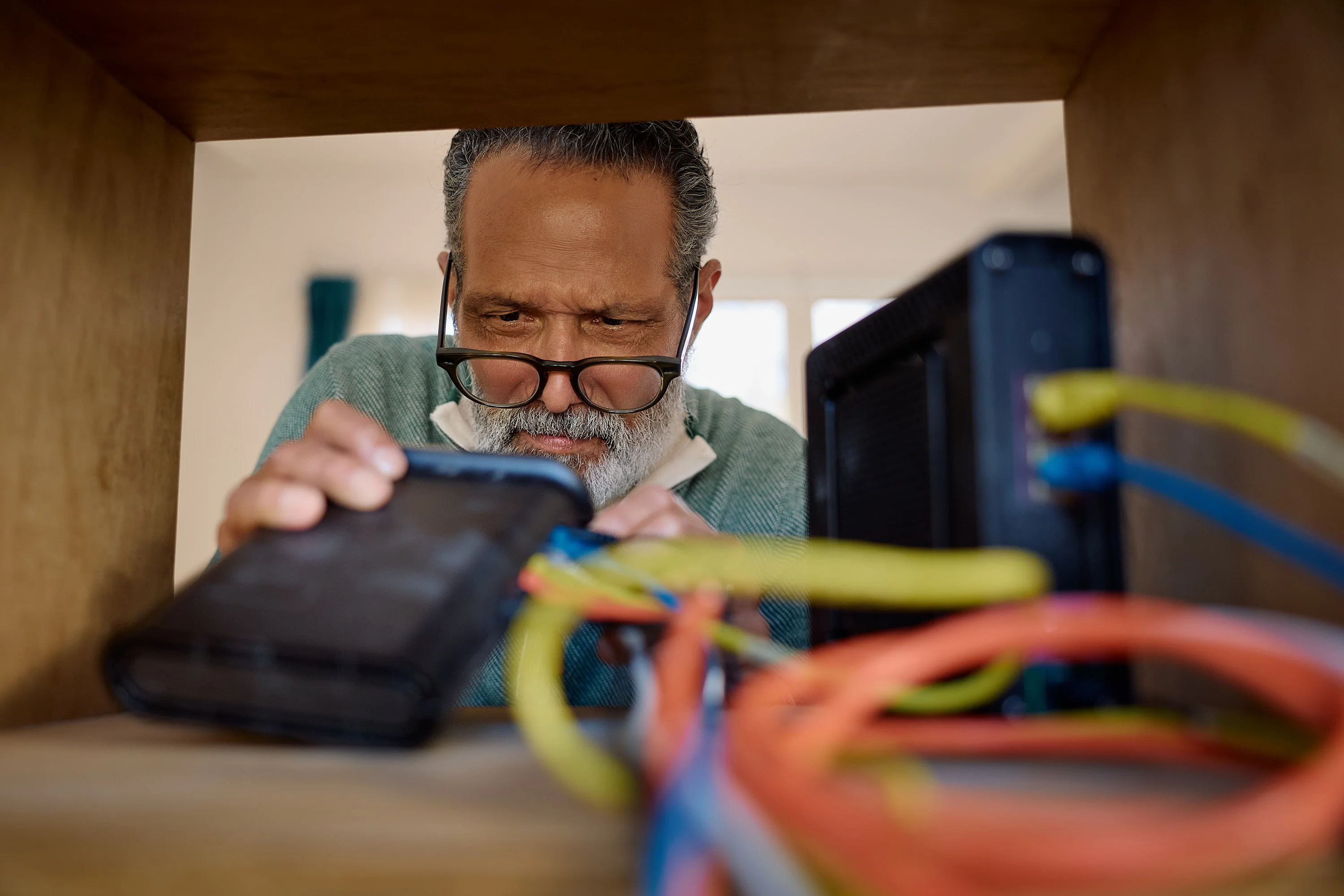 Anthony looking into a cabinet at a router in the eero campaign