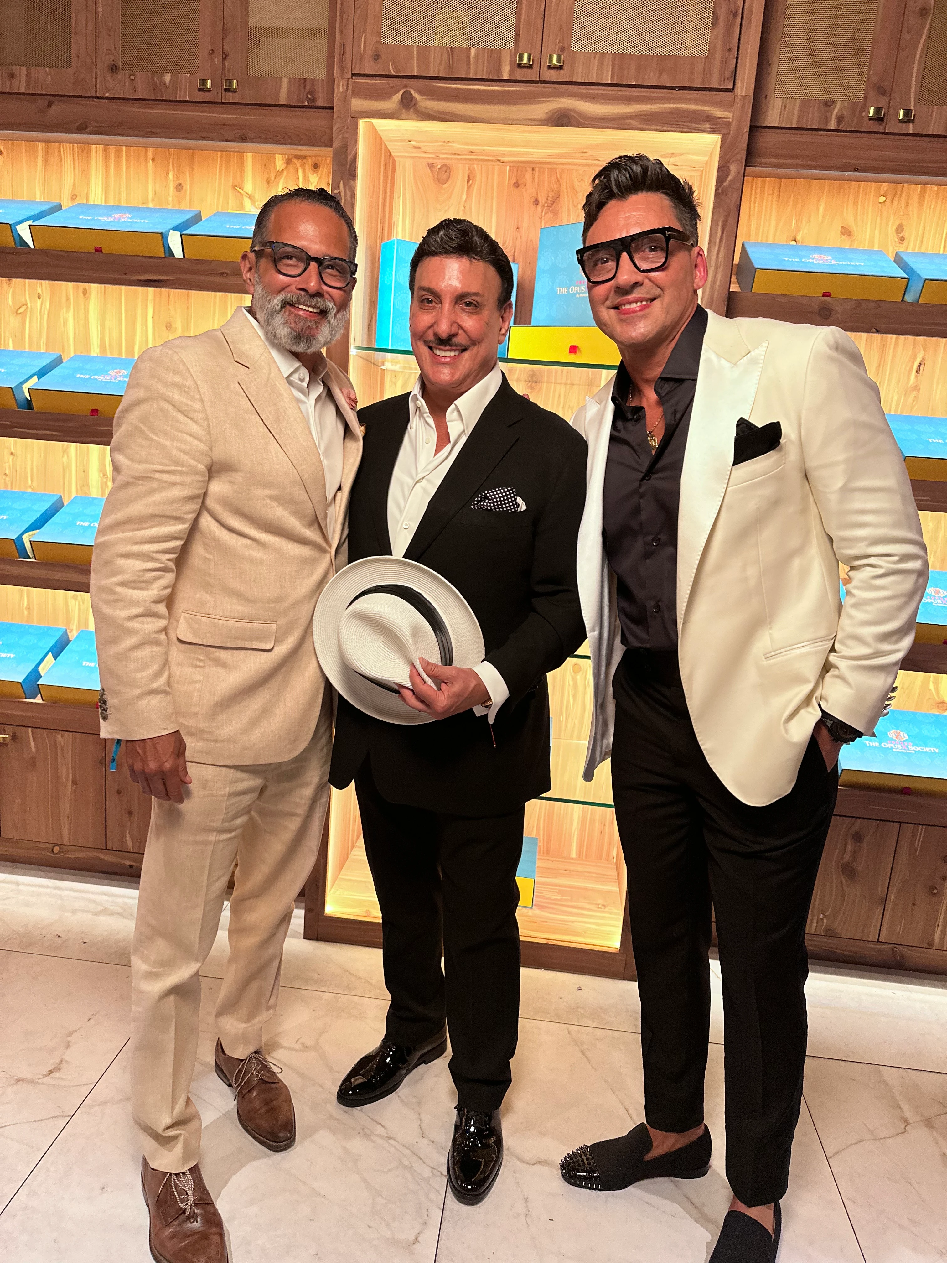 Anthony with Carlito Fuente Jr. and Manny Iriarte in a cigar room.