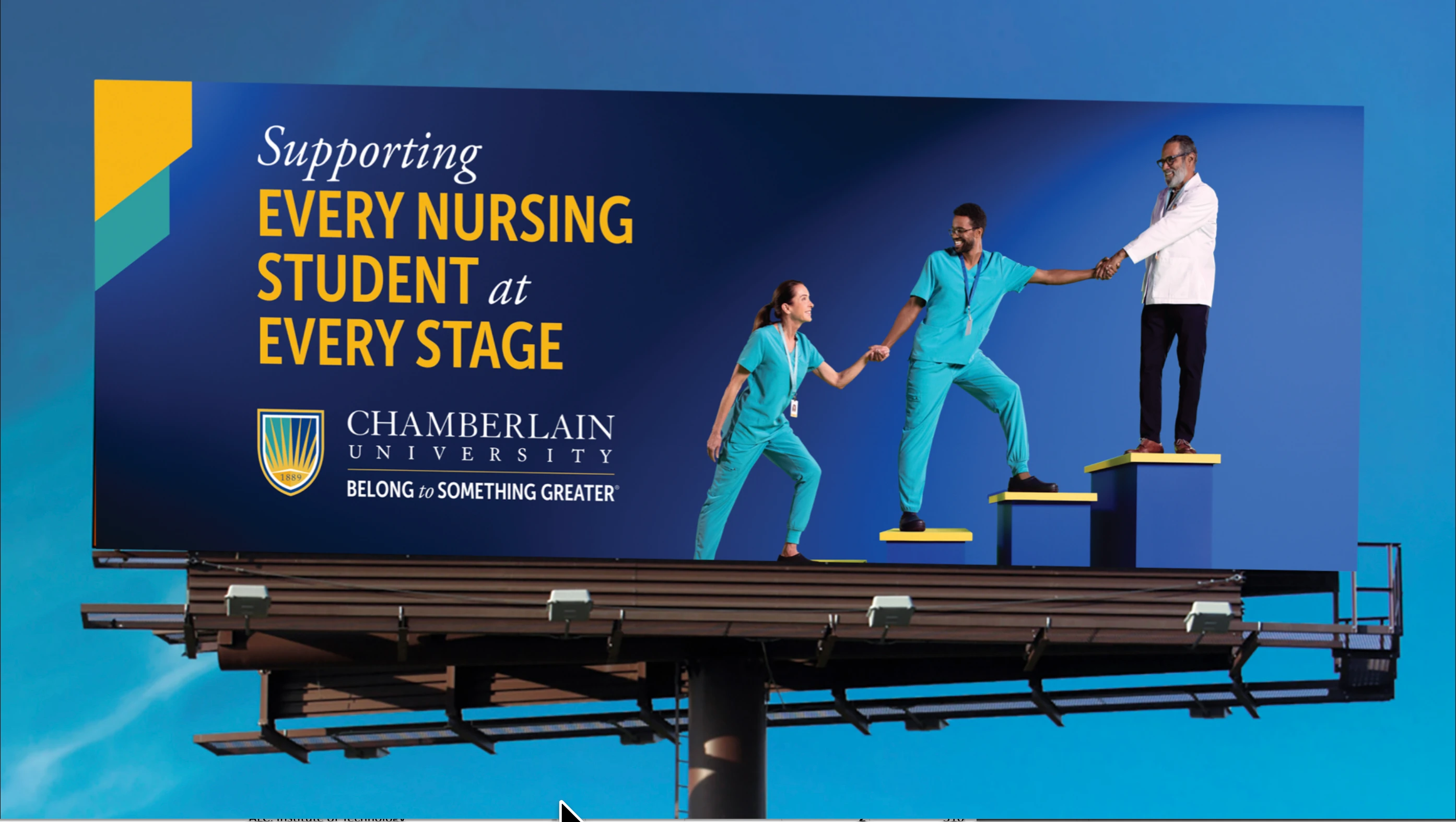 Chamberlain University billboard against the blue sky, with Anthony at the upper-right end of the ascending platforms